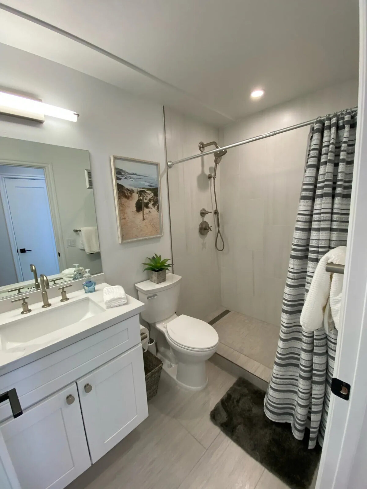 Updated bathroom with walk-in shower and white vanity