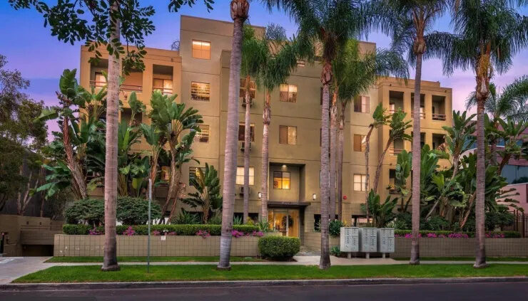 Exterior of the Live Work Play Hillcrest apartment building among palm trees