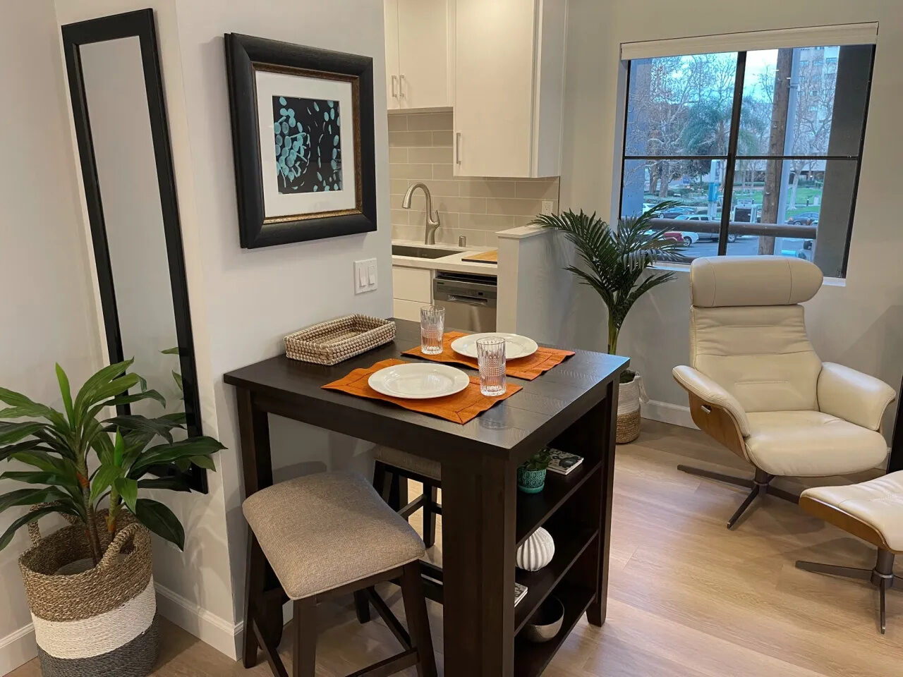 Dining table with kitchen and leather recliner in the background